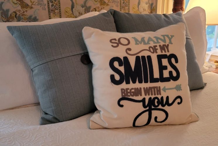 Decorative pillows on a cozy bed, cute pillow reading, 