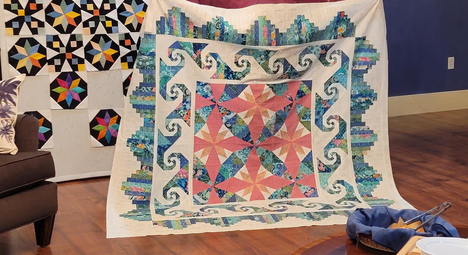 Multicolored quilt hanging on display