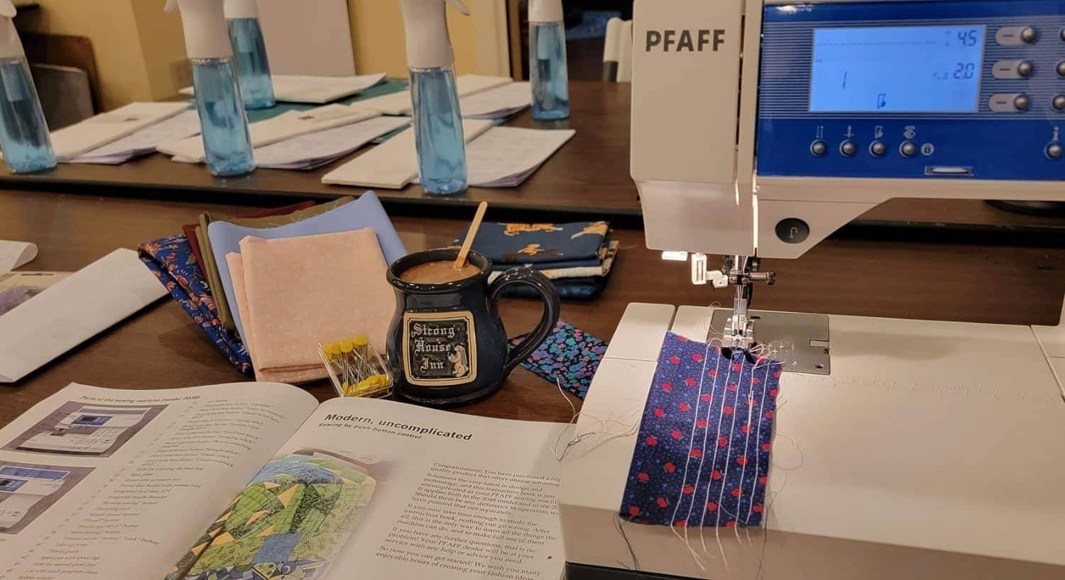 Close up view of sewing machine and quilting books